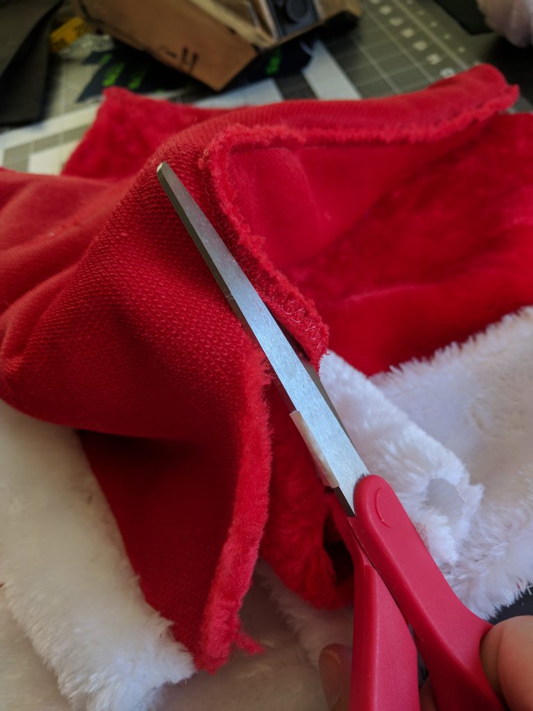 Cutting the seam off the Santa Hat.